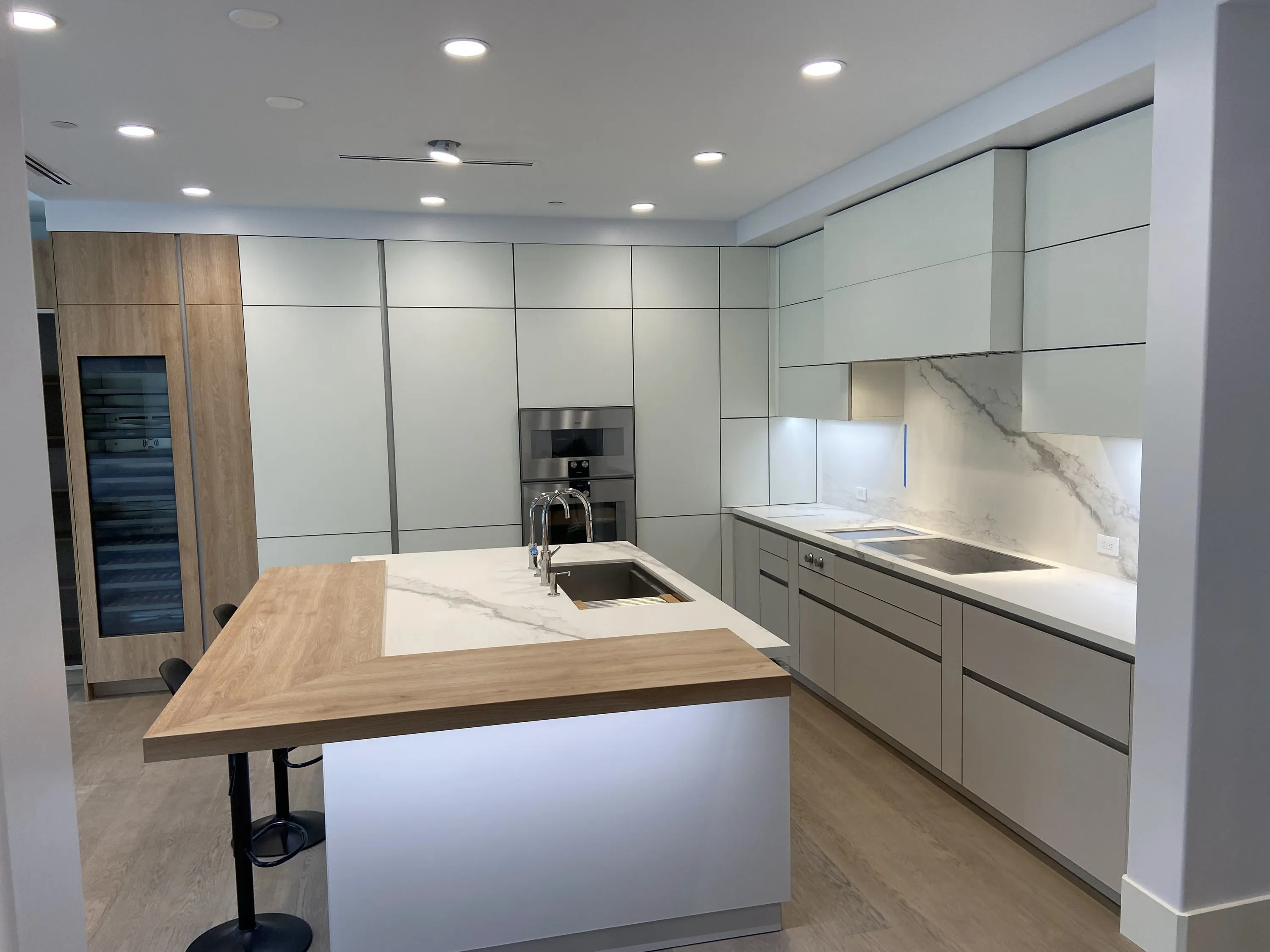 White island with wood counter and stone backsplash